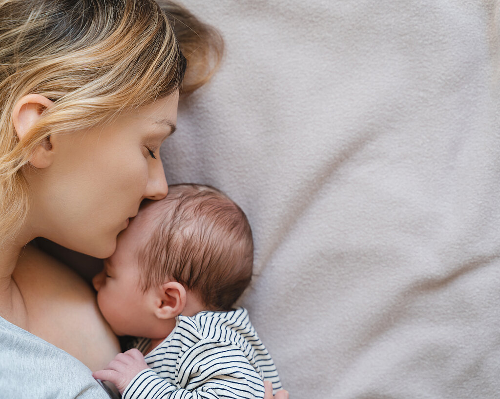 Mother breastfeeding baby. Baby eating mother's milk.
