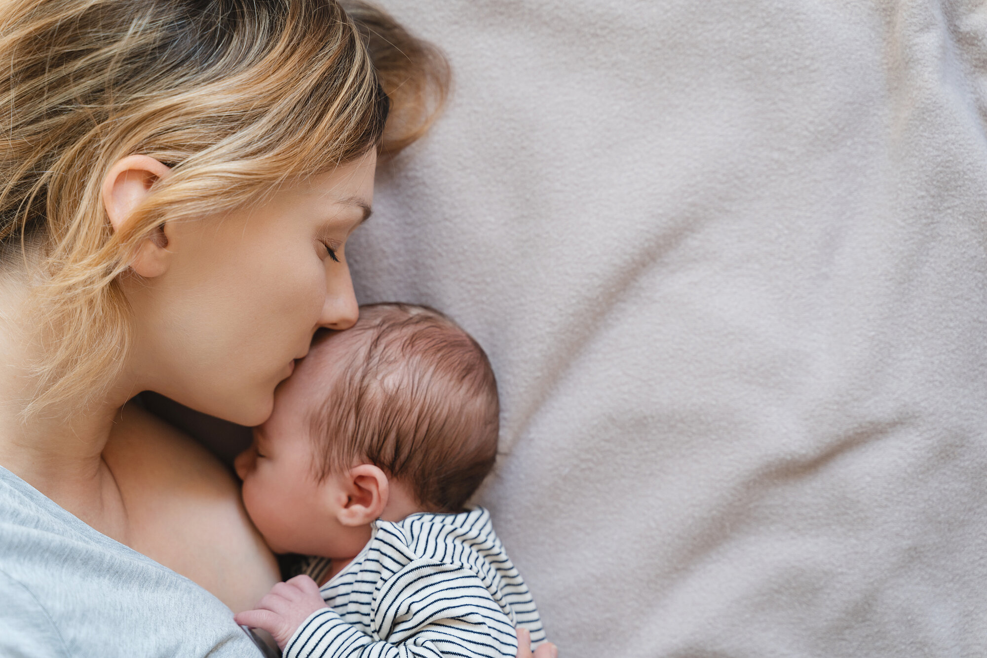 Mother breastfeeding baby. Baby eating mother's milk.