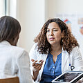 Female physician answers questions from her patient