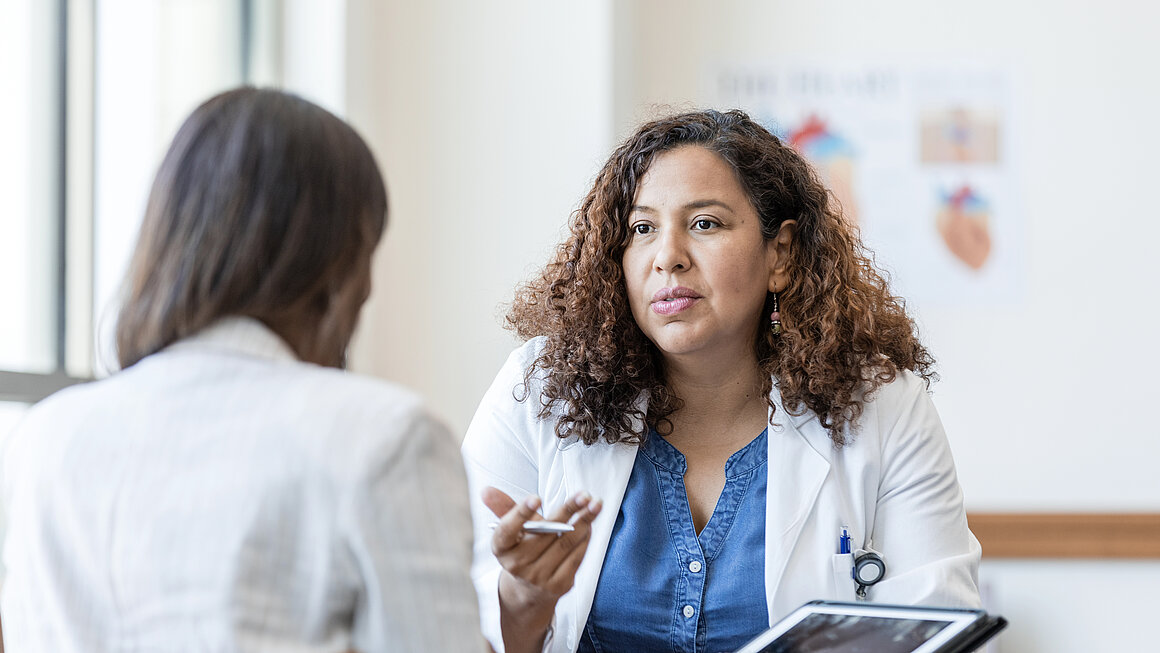 Female physician answers questions from her patient