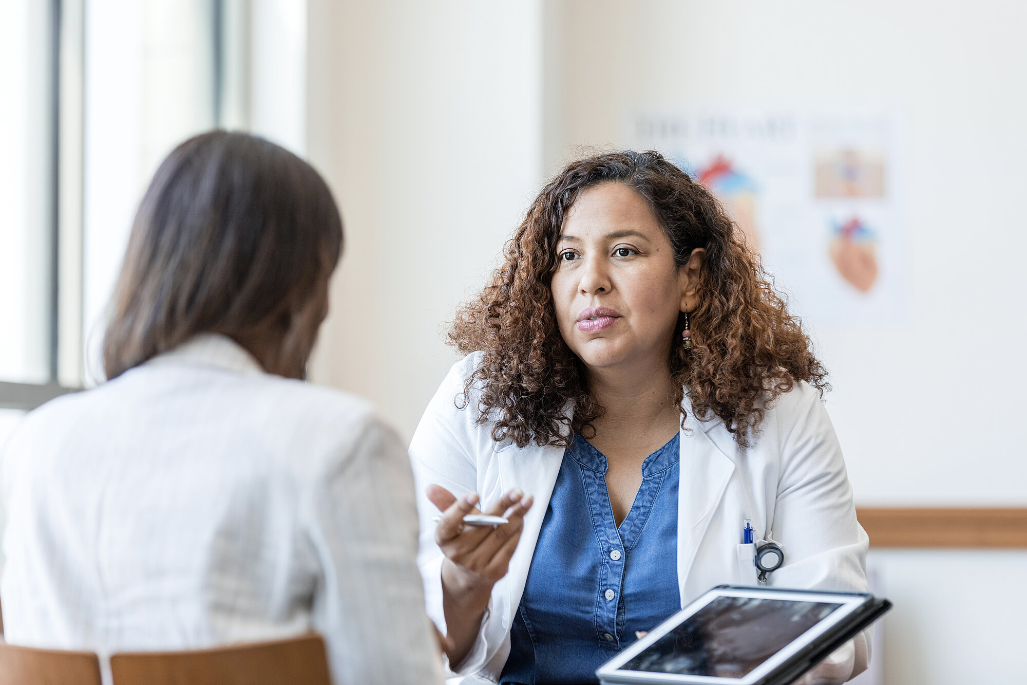 Female physician answers questions from her patient