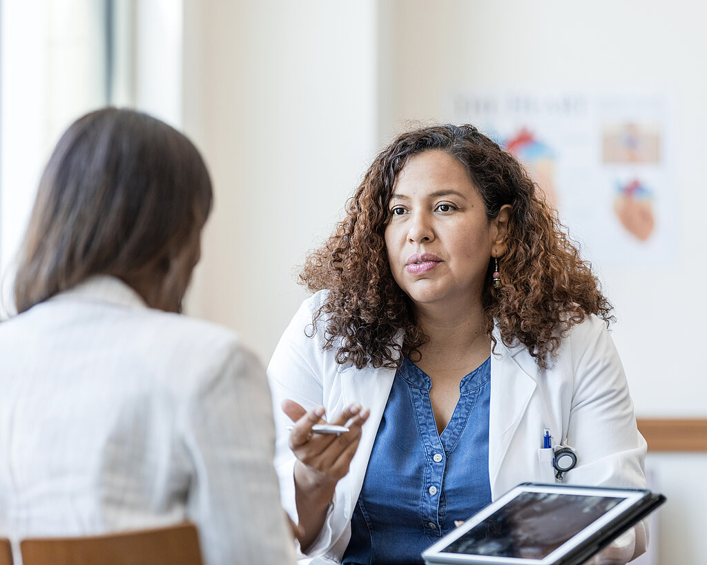 Female physician answers questions from her patient