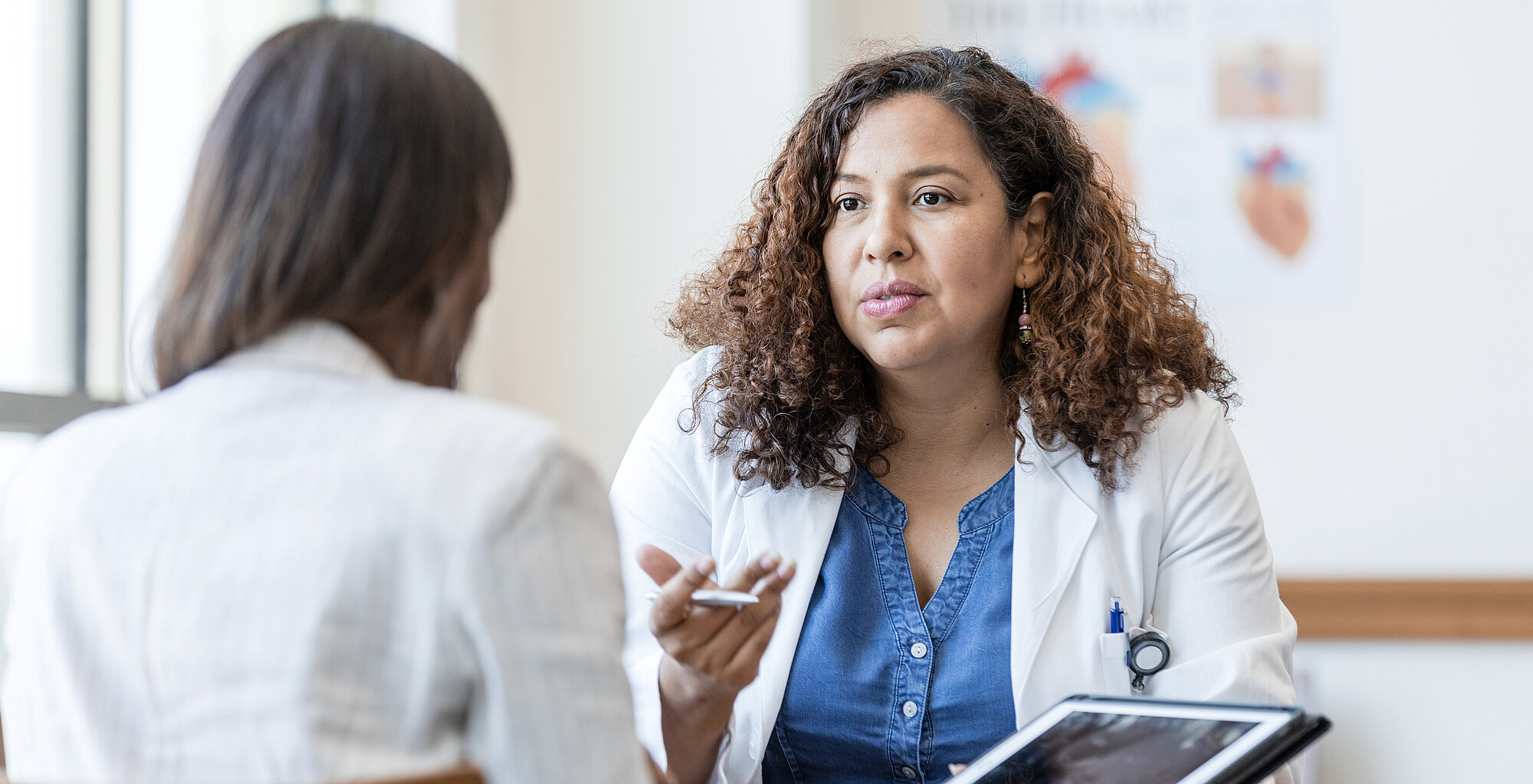 Female physician answers questions from her patient