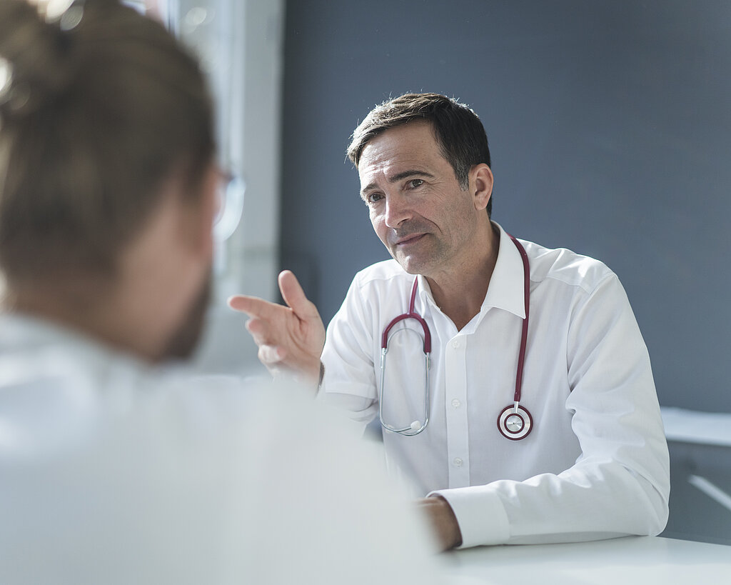 Doctor talking to patient in medical practice
