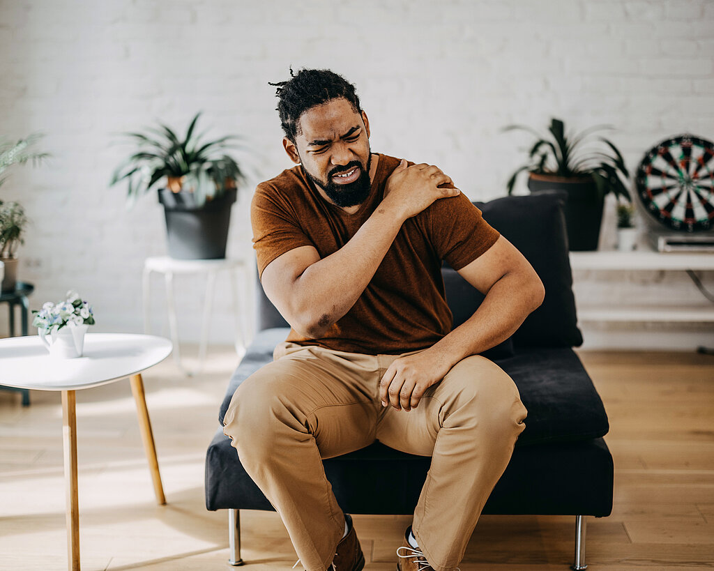 Middle aged man has shoulder pain. with copy space for text