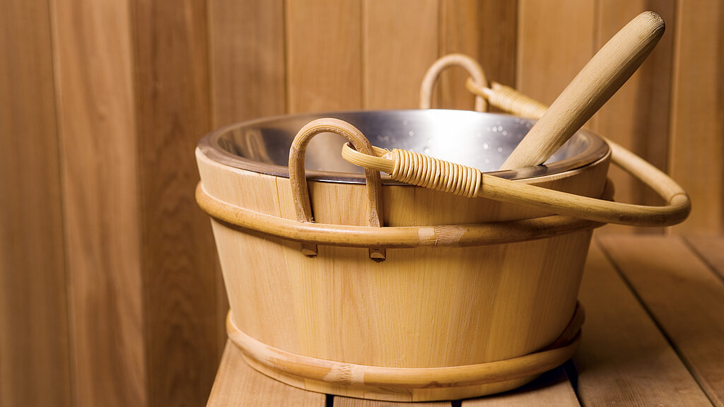 Wooden bucket in sauna