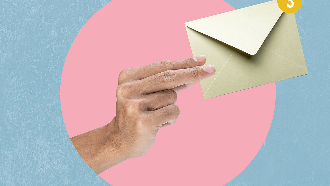 Human hand holding envelope letter with a colored background